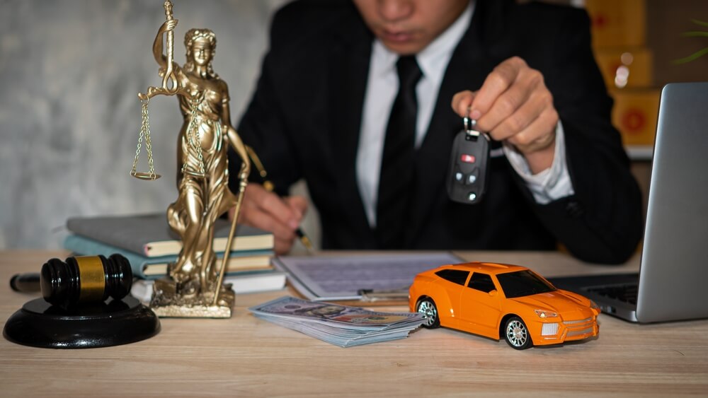 attorney holding car keys reviewing car accident claim for client