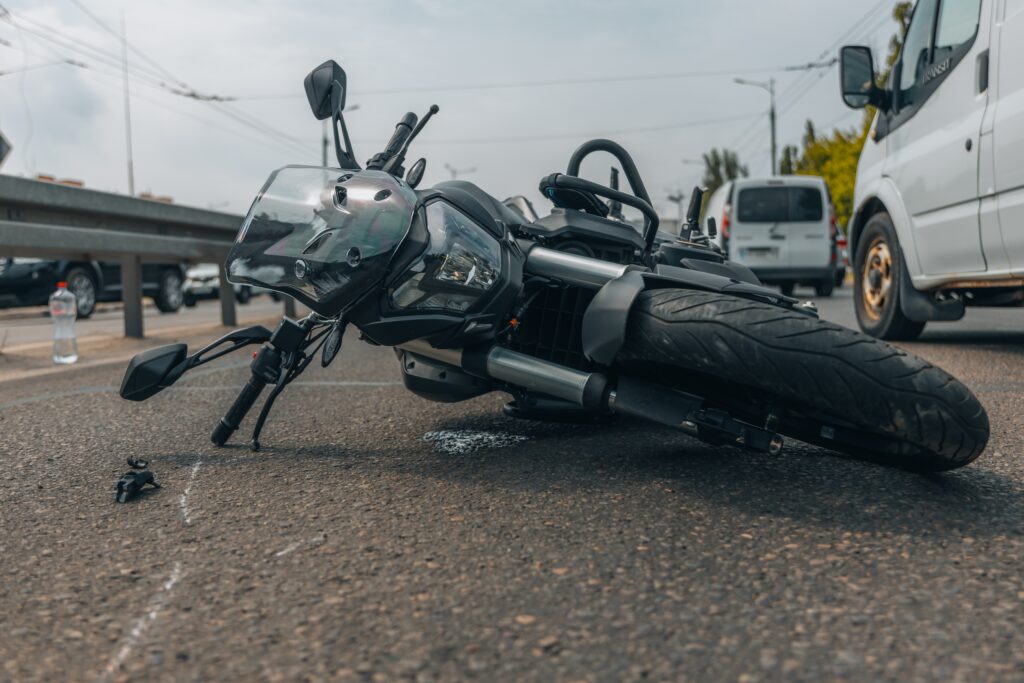 Damaged motorcycle lying on the road after a traffic accident.