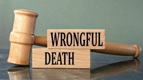 A judge’s gavel beside wooden blocks labeled “Wrongful Death,” symbolizing legal action guided by a Lincoln wrongful death lawyer.